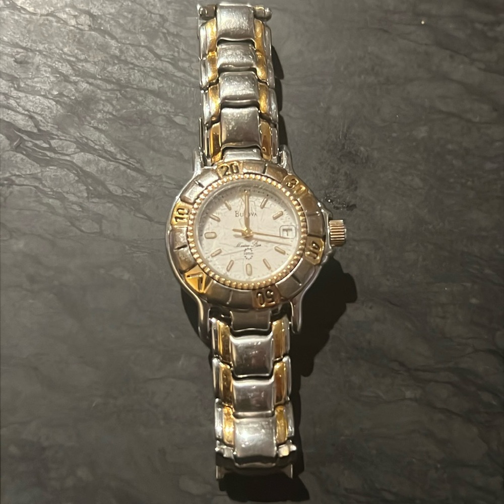 Bulova silver and gold women's watch.  Stainless steel case.